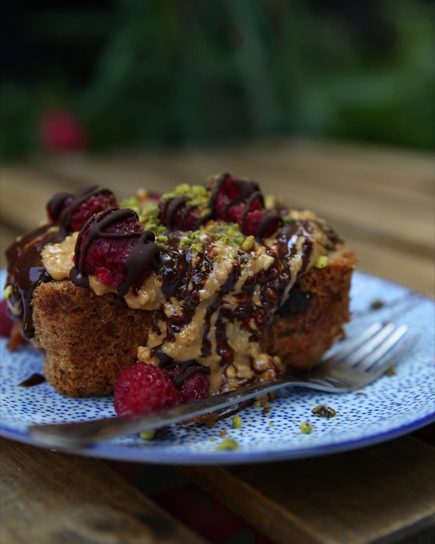 Crumb cake with raspberries on a blue plate
