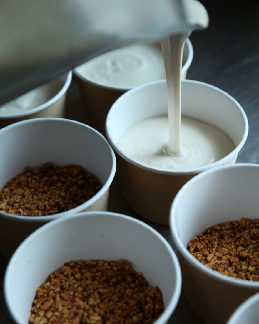Pouring cashew milk into chia cups