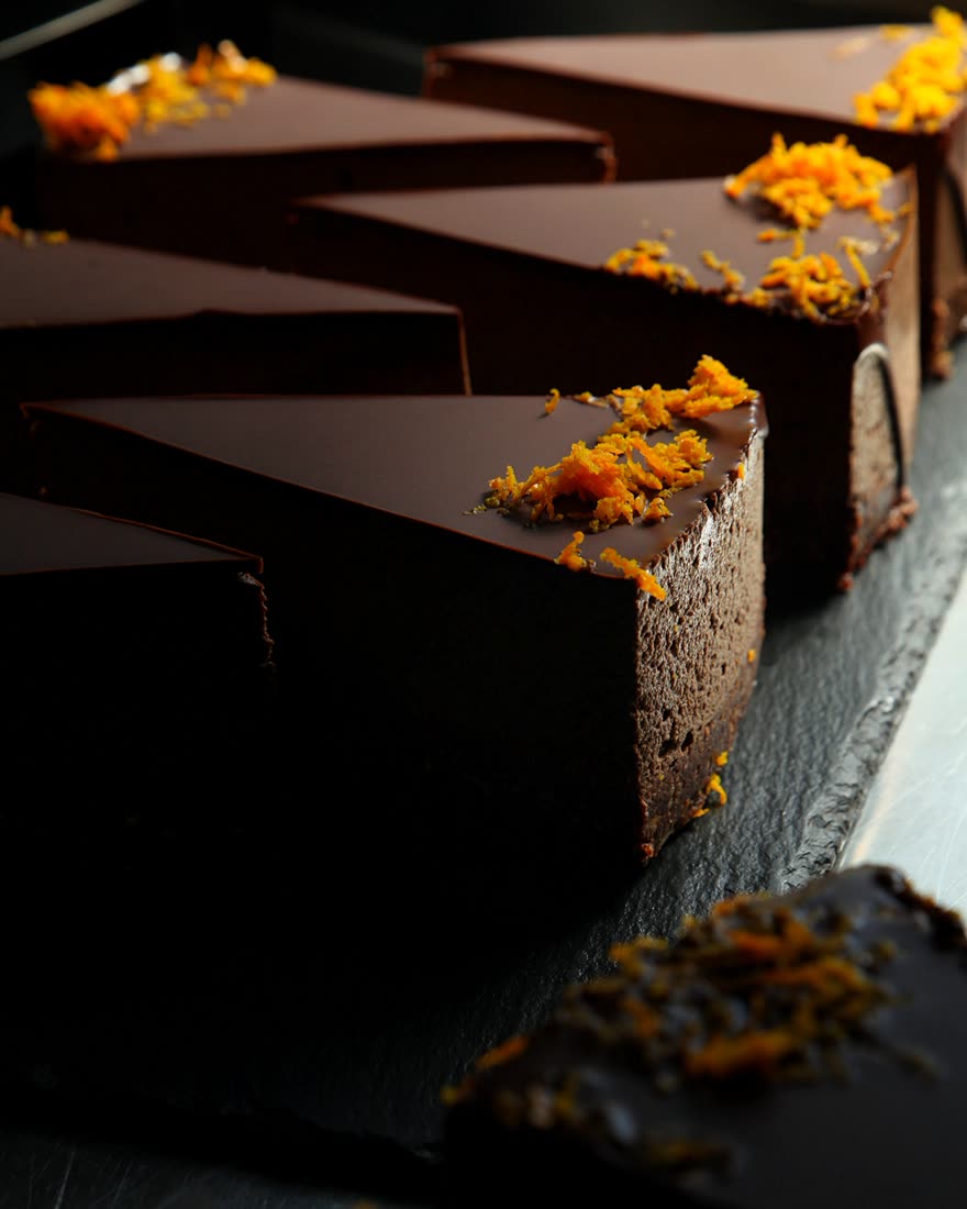 Dark chocolate cake slices with orange zest